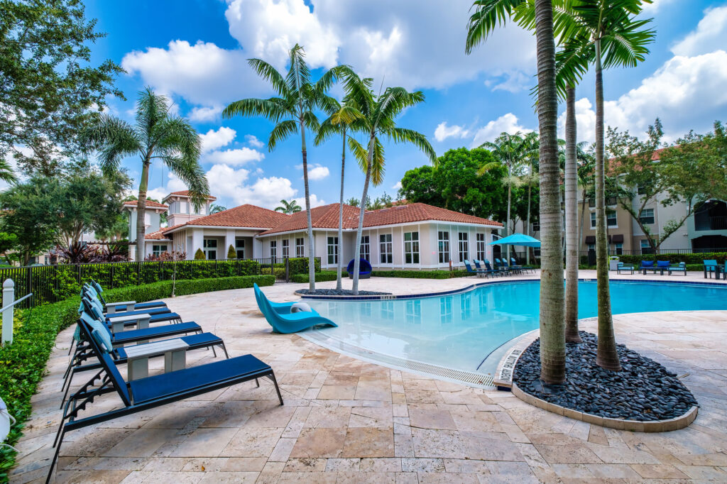 Pool with palm trees and deck seating