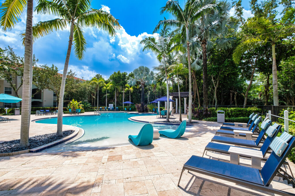 Pool with palm trees and deck seating